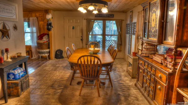a view of a dining room with furniture and chandelier kitchen view