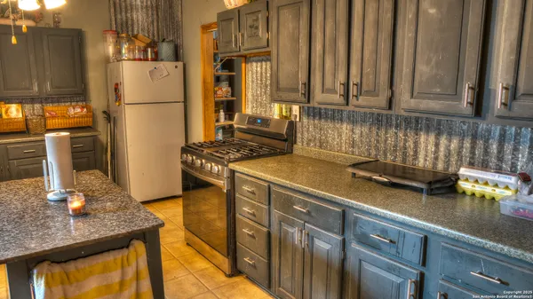 a kitchen with stainless steel appliances granite countertop a sink refrigerator and stove
