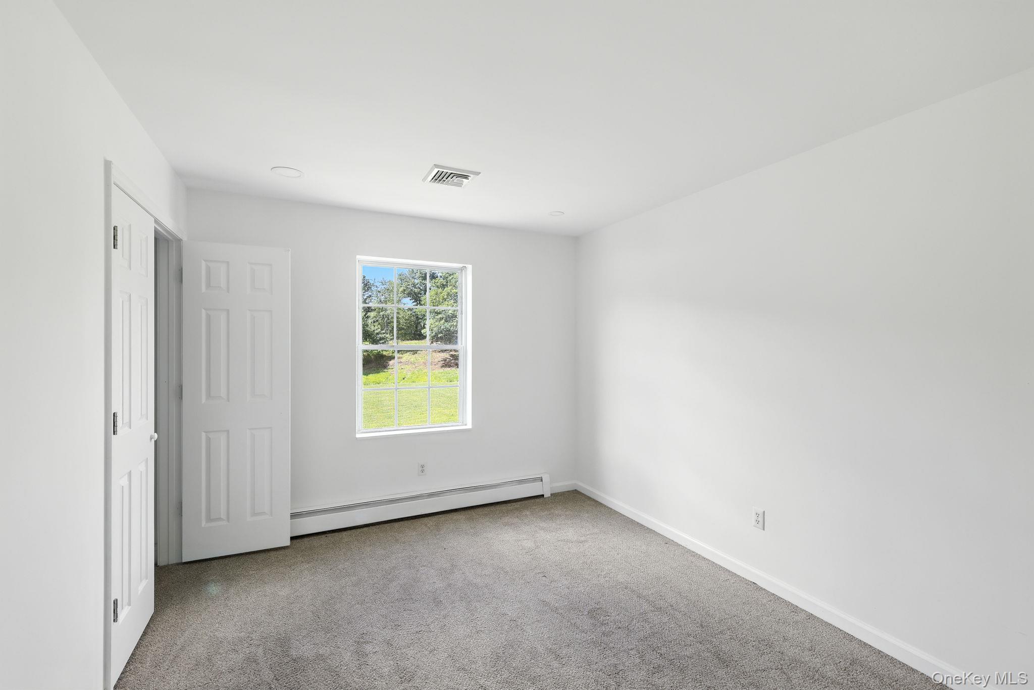 160 Pirog Road Pine Bush, NY 12566 - Photo 12 of 26 Unfurnished bedroom with carpet flooring and baseboard heating