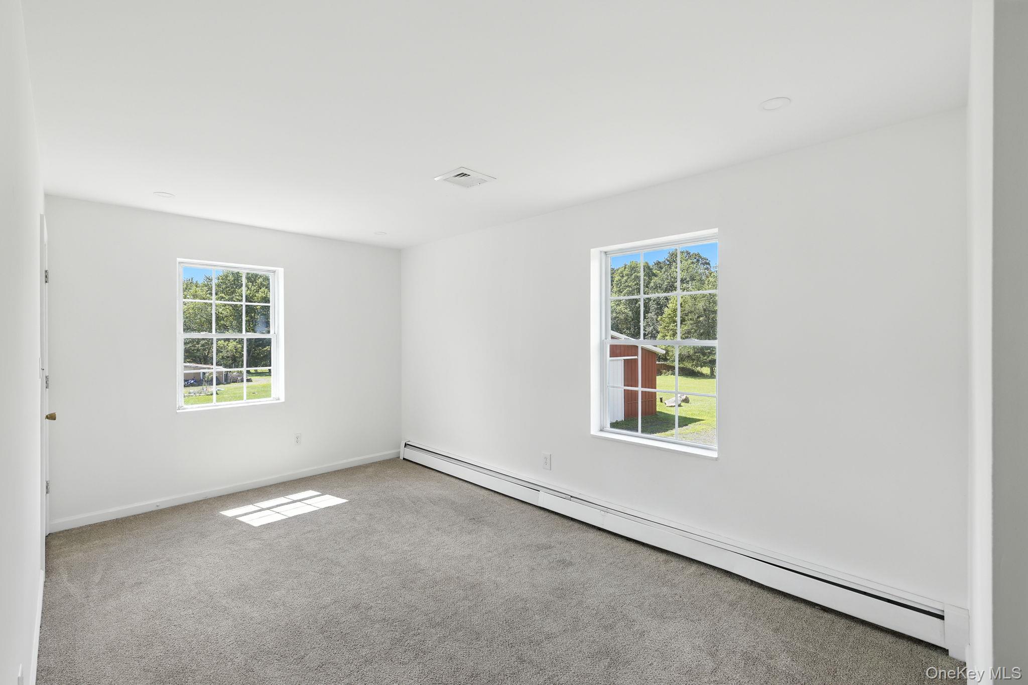 160 Pirog Road Pine Bush, NY 12566 - Photo 13 of 26 Carpeted empty room with a baseboard radiator and baseboards