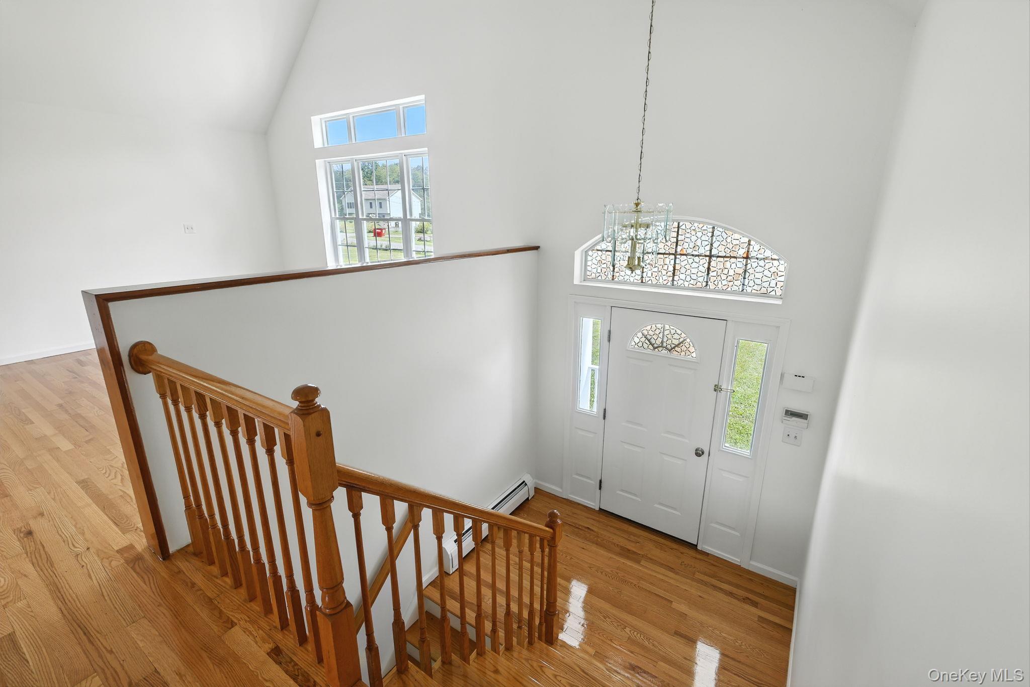 160 Pirog Road Pine Bush, NY 12566 - Photo 10 of 26 Entrance foyer featuring high vaulted ceiling, light wood-style flooring, and a chandelier