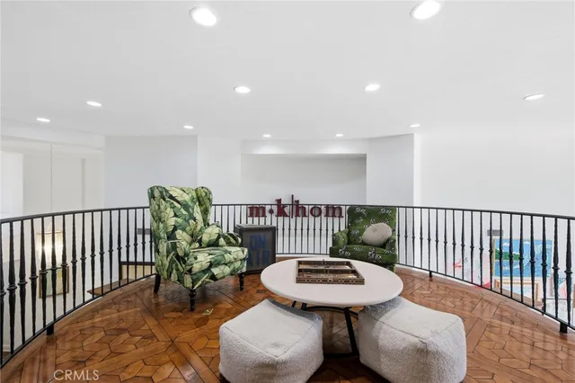 a hallway with a bookshelf and a painting on the wall