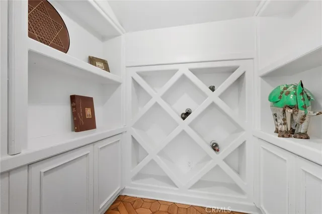 a hallway with cabinets and wooden floor