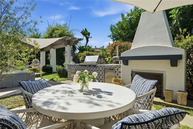 a view of a house with sitting area and garden