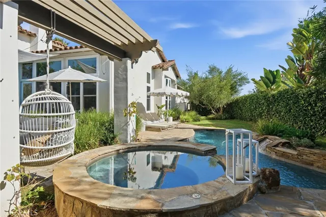 a view of a patio with couches table and chairs and potted plants