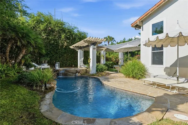 a view of a backyard with table and chairs and a large tree