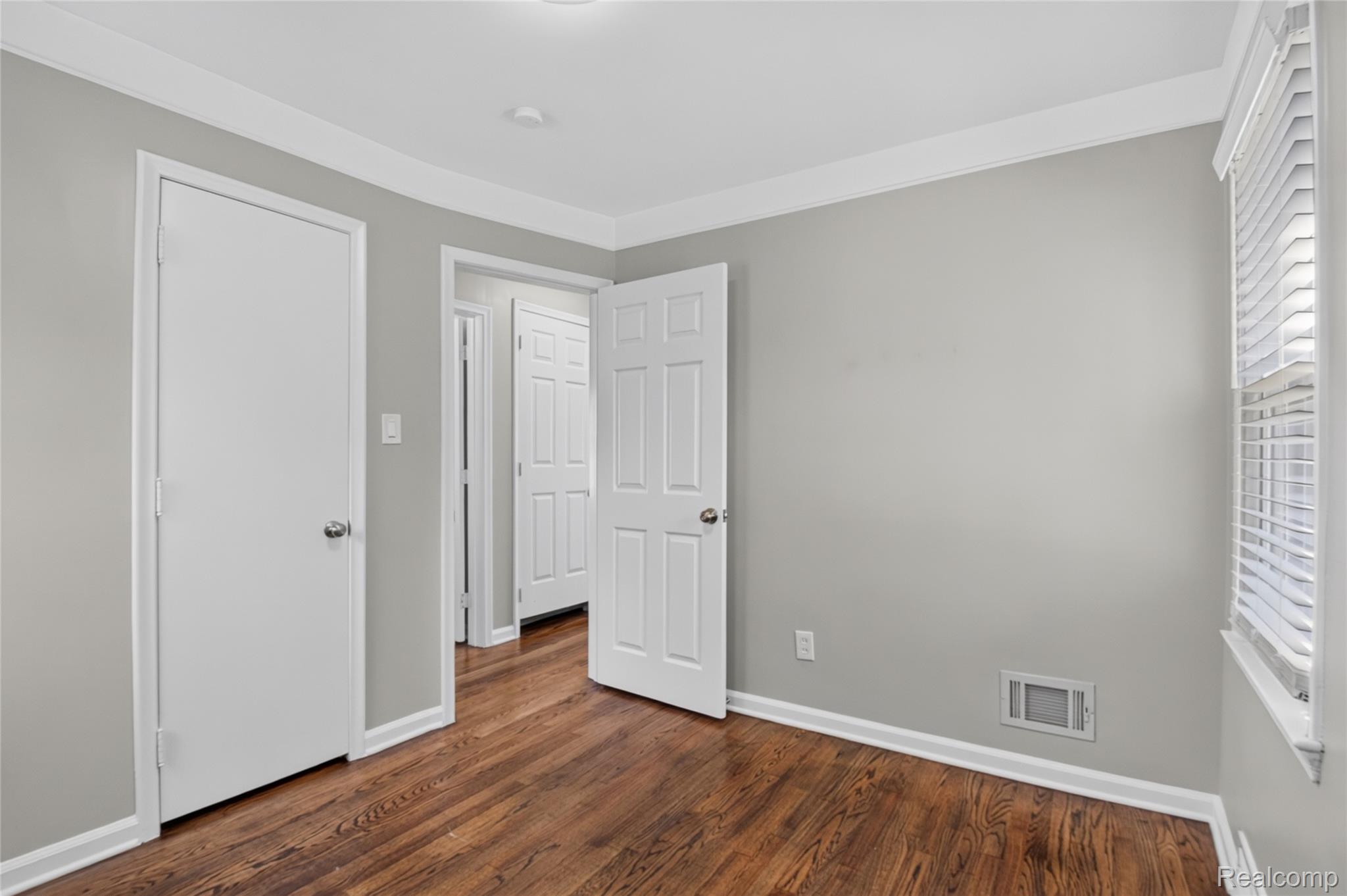 12972 Callender Street Southgate, MI 48195 - Photo 21 of 40 Interior room featuring rich wood-finish flooring, light gray walls, and white trim