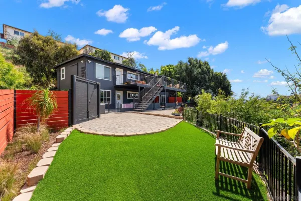 a view of a house with backyard and porch