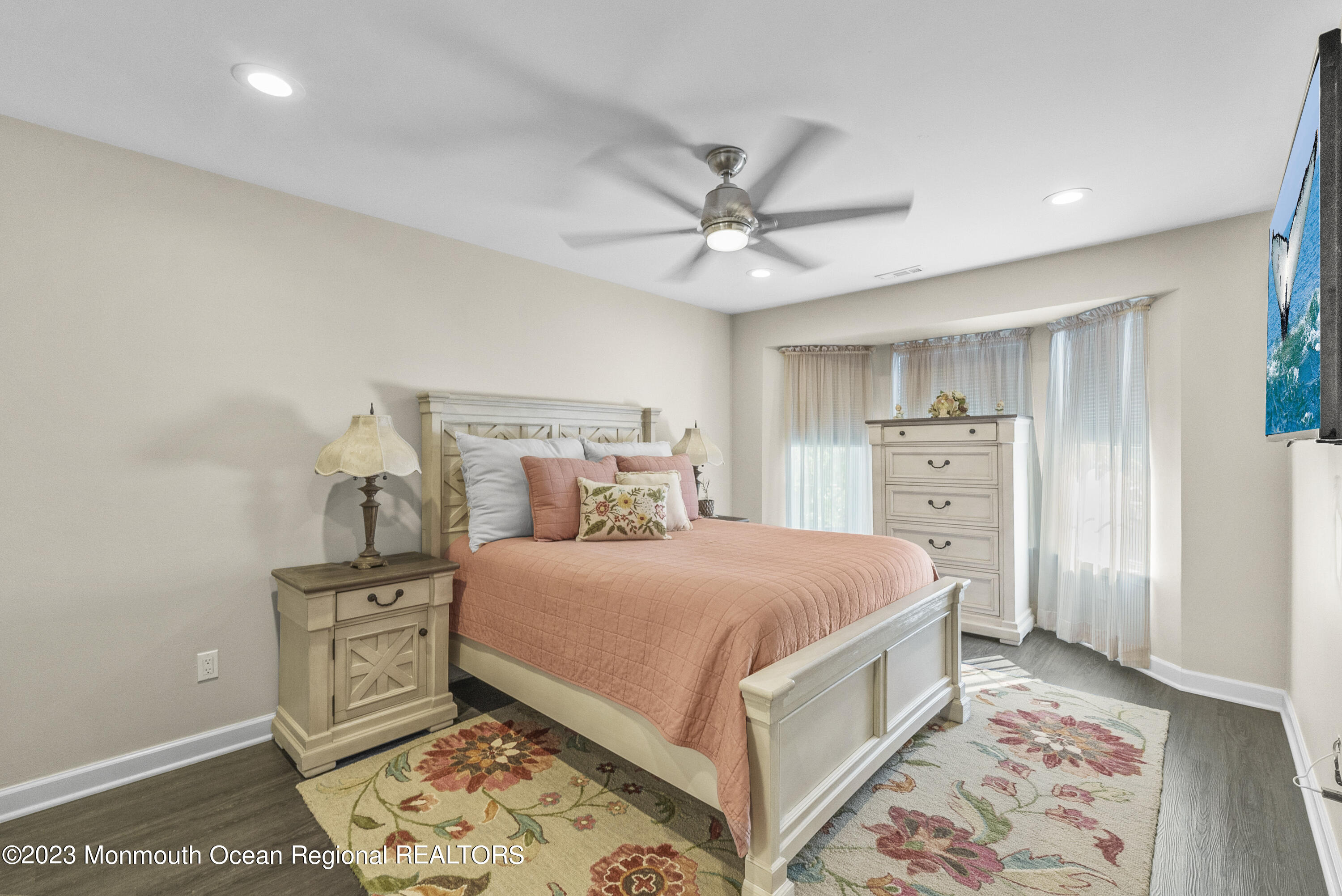 186 Tulip Lane Freehold, NJ 07728 - Photo 15 of 18 a bedroom with a large bed and a chandelier