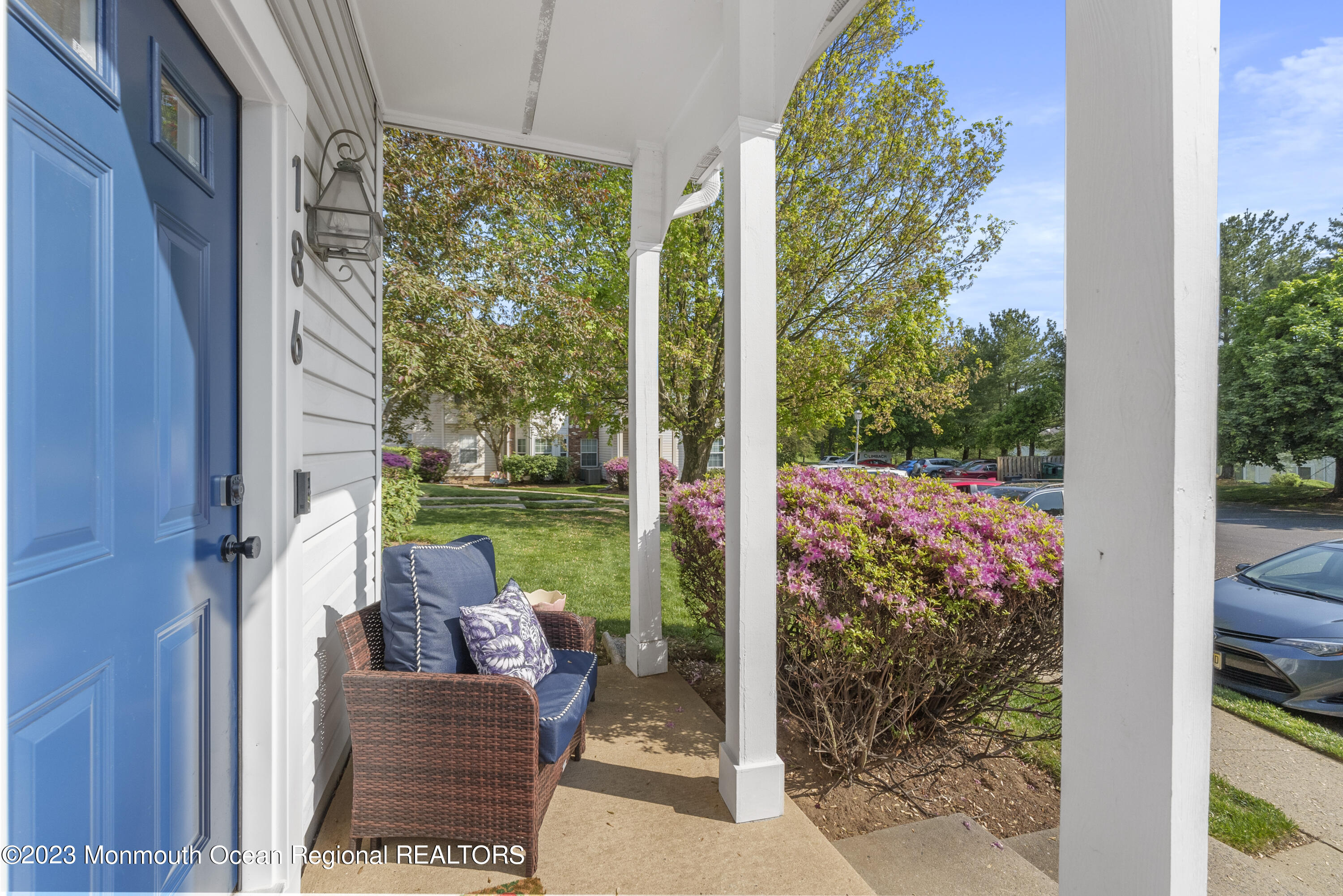 186 Tulip Lane Freehold, NJ 07728 - Photo 2 of 18 a view of a patio with table and chairs potted plants with wooden floor