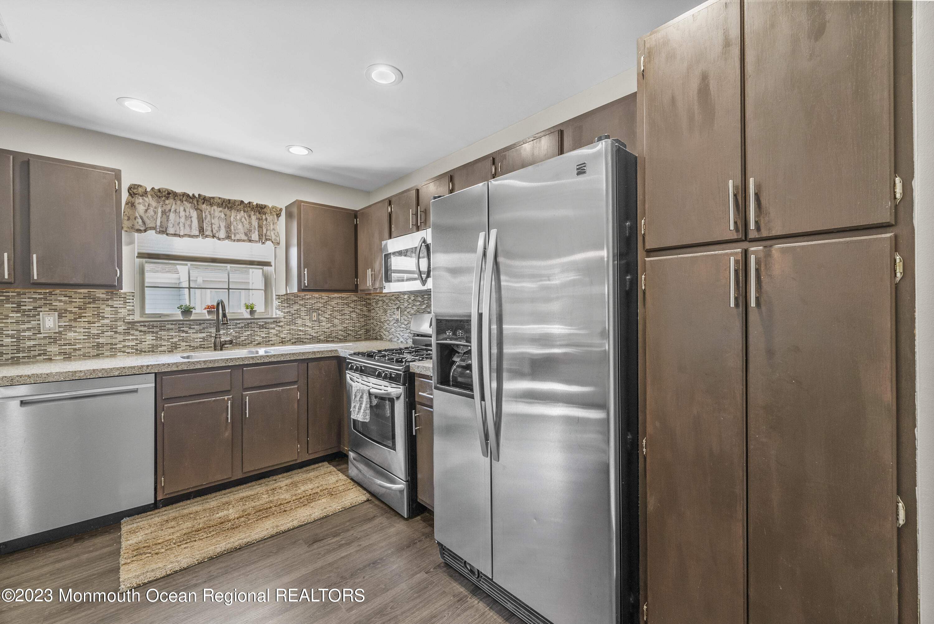 186 Tulip Lane Freehold, NJ 07728 - Photo 9 of 18 a kitchen with stainless steel appliances granite countertop a refrigerator and a sink