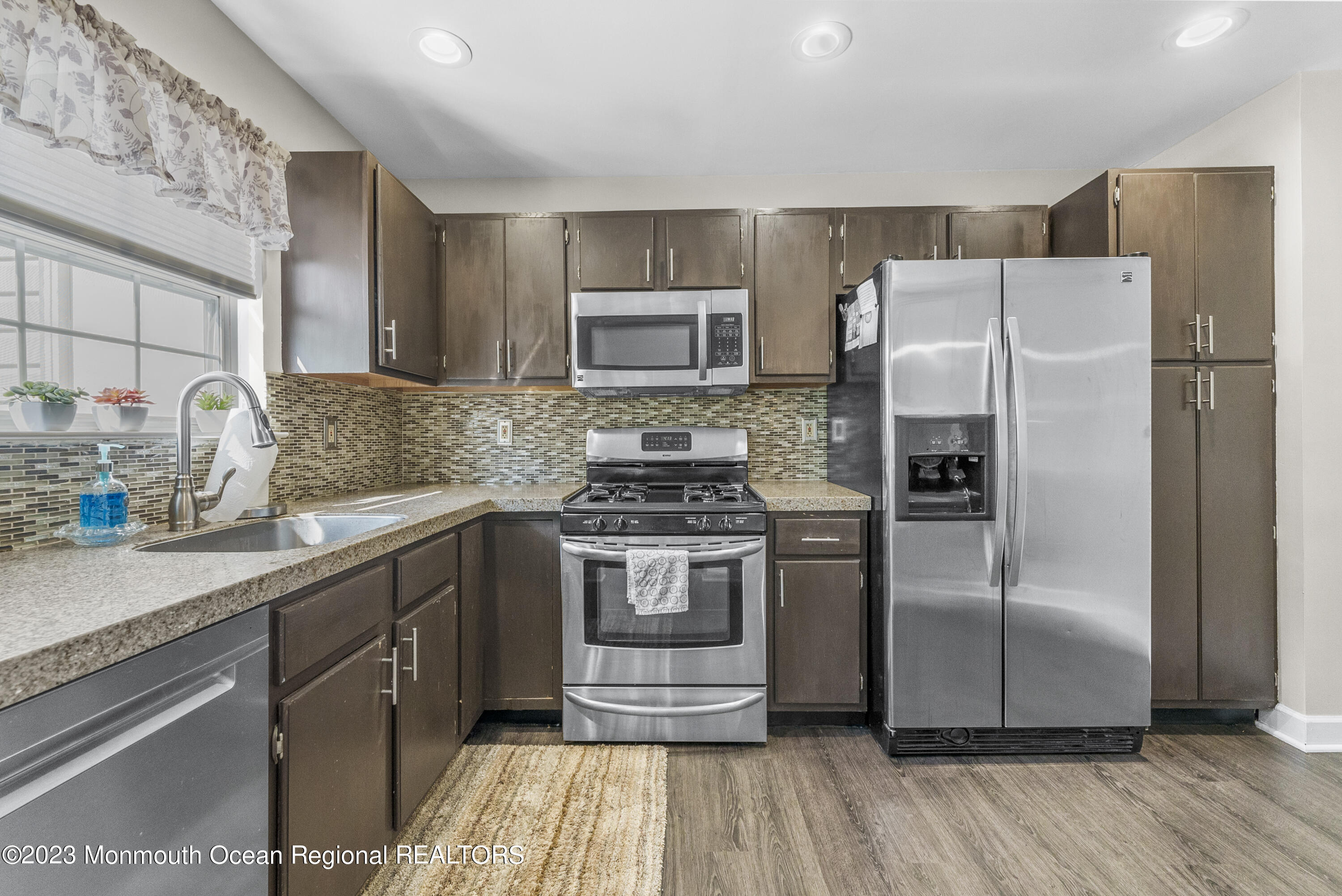 186 Tulip Lane Freehold, NJ 07728 - Photo 10 of 18 a kitchen with a refrigerator sink and microwave