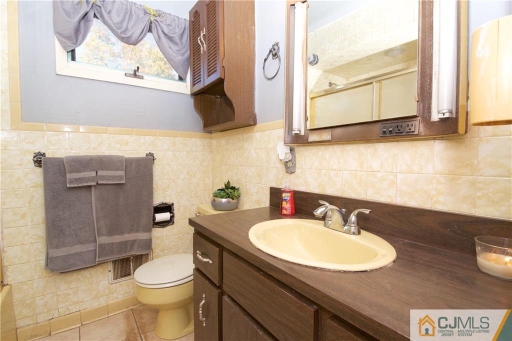 71 South Pennington Road New Brunswick, NJ 08901 - Photo 11 of 24 a bathroom with a sink a toilet and mirror