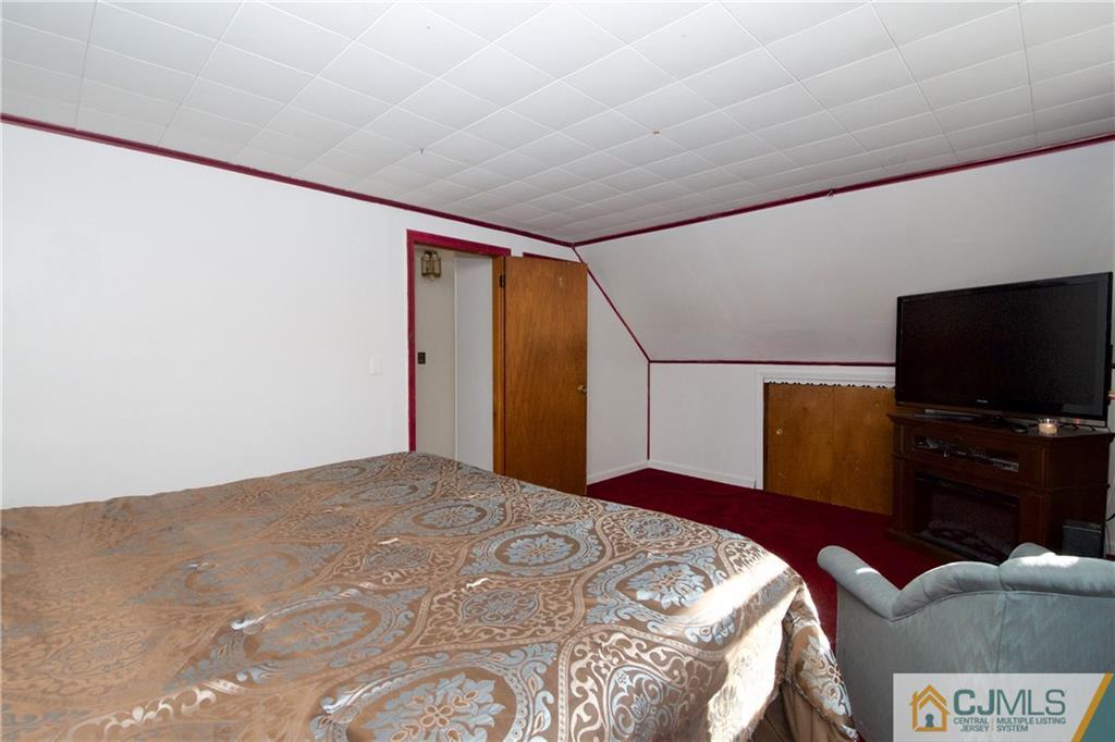 71 South Pennington Road New Brunswick, NJ 08901 - Photo 15 of 24 a bedroom with a bed and a flat screen tv