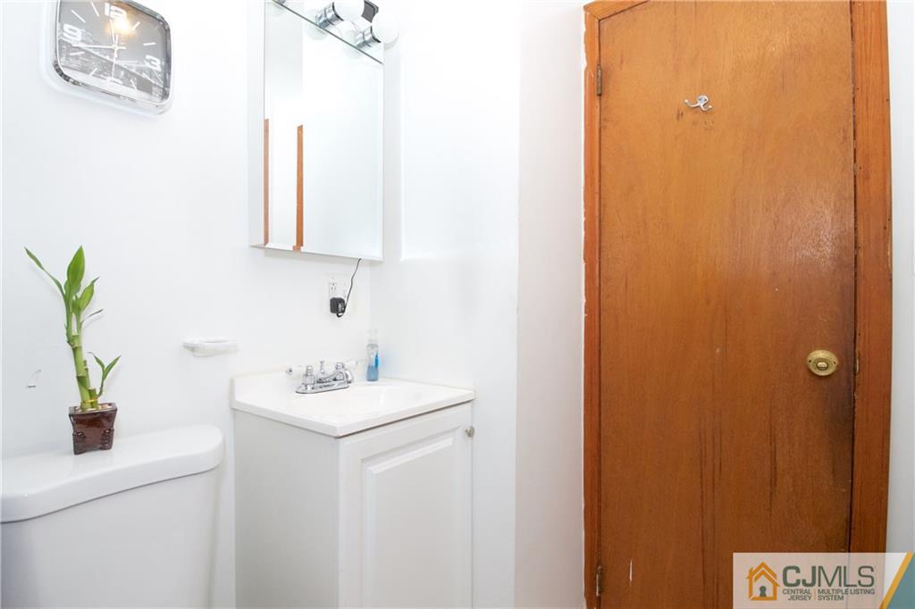 71 South Pennington Road New Brunswick, NJ 08901 - Photo 19 of 24 a bathroom with a sink a mirror and a shower