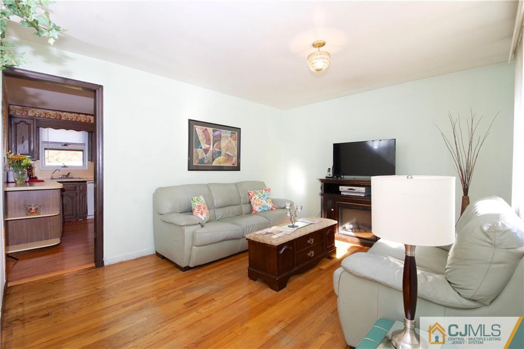 71 South Pennington Road New Brunswick, NJ 08901 - Photo 4 of 24 a living room with furniture and a flat screen tv
