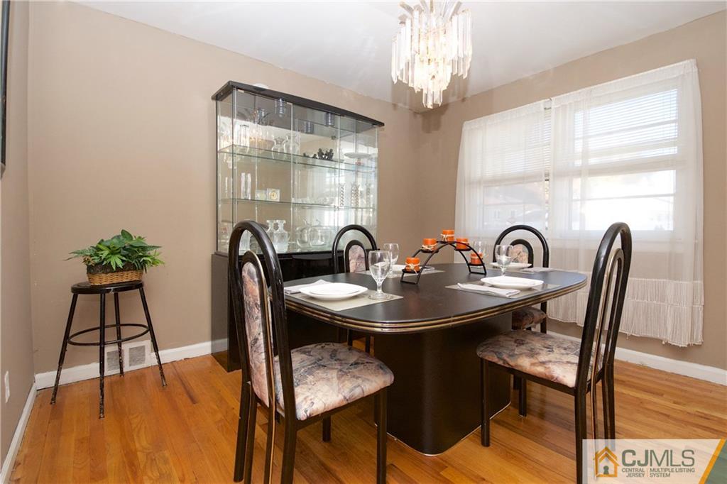 71 South Pennington Road New Brunswick, NJ 08901 - Photo 7 of 24 a view of a dining room with furniture a chandelier and wooden floor