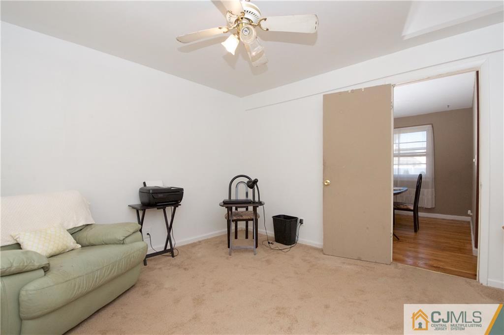 71 South Pennington Road New Brunswick, NJ 08901 - Photo 10 of 24 a living room with furniture a chandelier and a rug