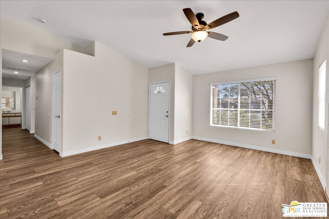 68130 Hermosillo Road Cathedral City, CA 92234 - Photo 11 of 49 a view of an empty room with wooden floor and a window