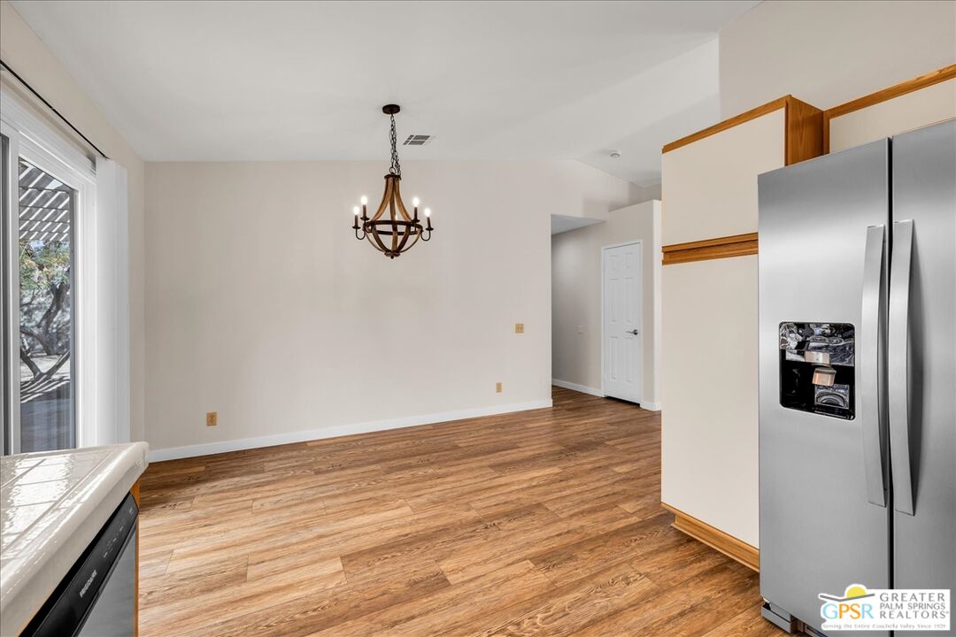 68130 Hermosillo Road Cathedral City, CA 92234 - Photo 20 of 49 a view of a livingroom with wooden floor and refrigerator