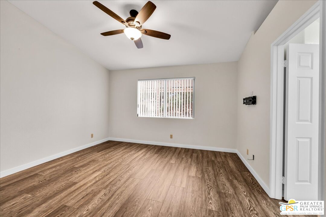 68130 Hermosillo Road Cathedral City, CA 92234 - Photo 22 of 49 wooden floor in an empty room with a window