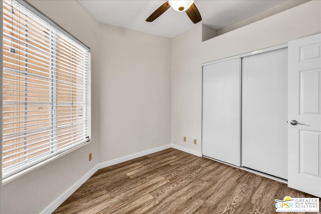 68130 Hermosillo Road Cathedral City, CA 92234 - Photo 26 of 49 a view of empty room with wooden floor and fan