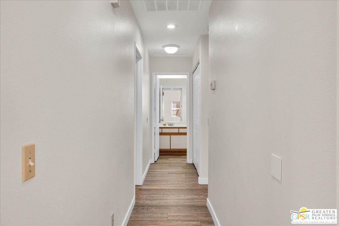 68130 Hermosillo Road Cathedral City, CA 92234 - Photo 28 of 49 a view of a hallway with wooden floor and a bathroom