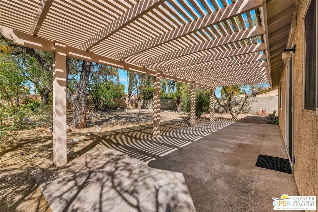 68130 Hermosillo Road Cathedral City, CA 92234 - Photo 33 of 49 a view of a porch with a table chair and wooden floor