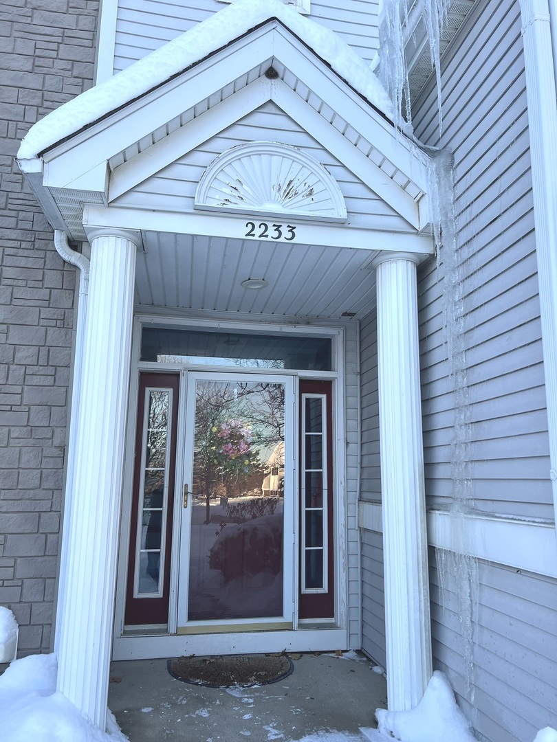 2233 Dawson Lane Algonquin, IL 60102 - Photo 2 of 52 a front view of a house with a glass door