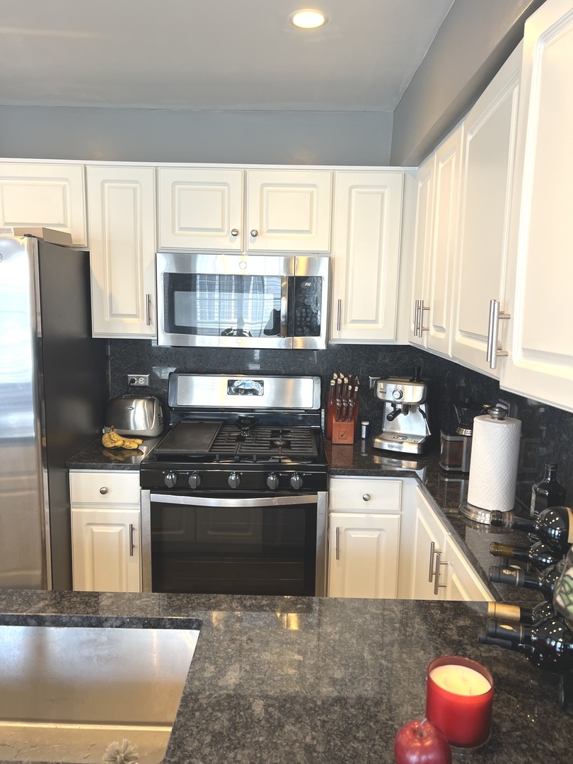 2233 Dawson Lane Algonquin, IL 60102 - Photo 9 of 52 a kitchen with stainless steel appliances granite countertop a stove a sink dishwasher and a microwave