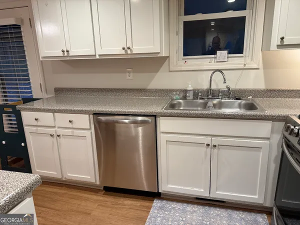 a kitchen with granite countertop cabinets and white appliances