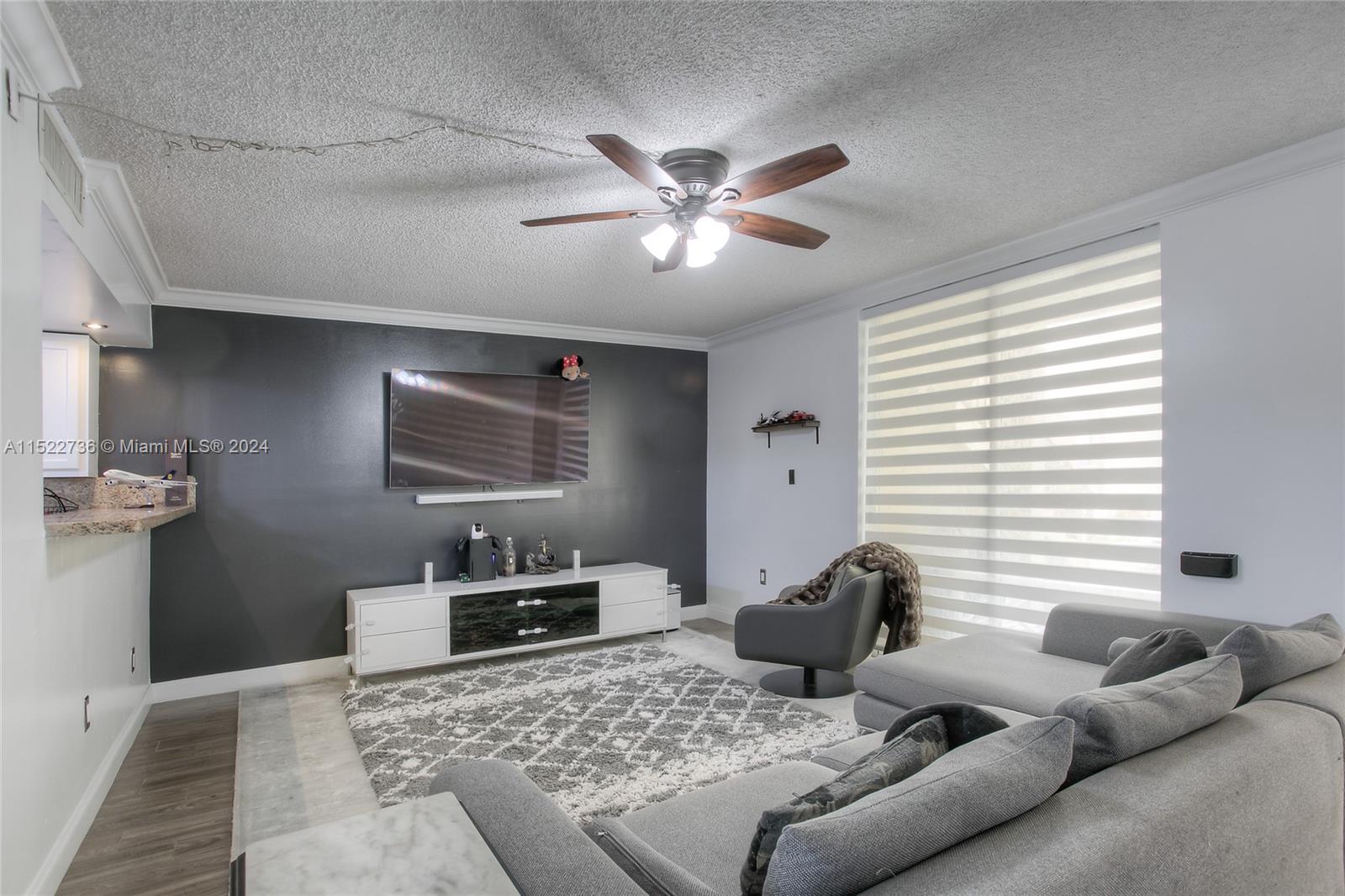 8401 West Sample Road, Unit 35 Coral Springs, FL 33065 - Photo 4 of 13 a living room with furniture and a window