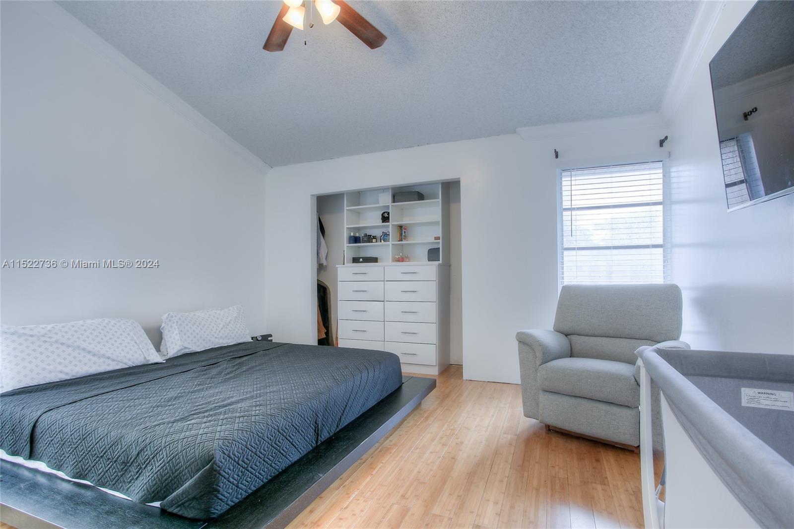 8401 West Sample Road, Unit 35 Coral Springs, FL 33065 - Photo 8 of 13 a bedroom with a bed and a couch