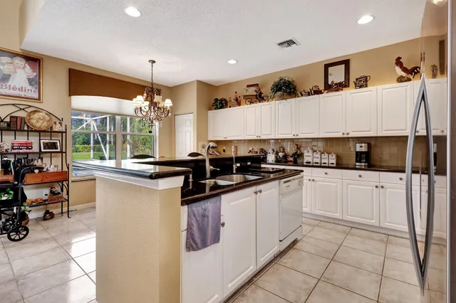 a kitchen with stainless steel appliances granite countertop a sink and cabinets