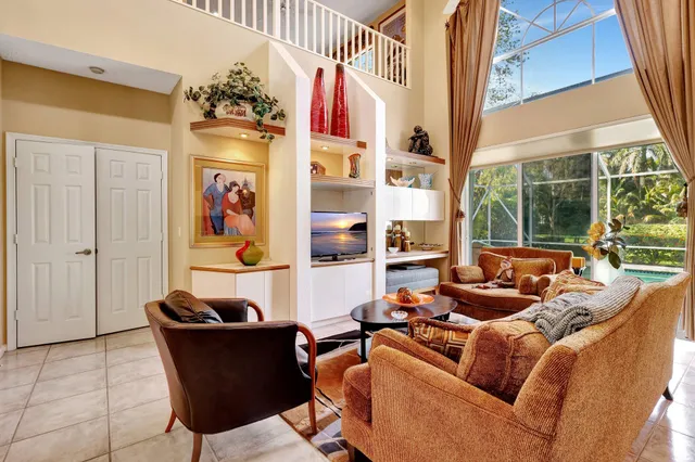 a living room with fireplace furniture and a large window