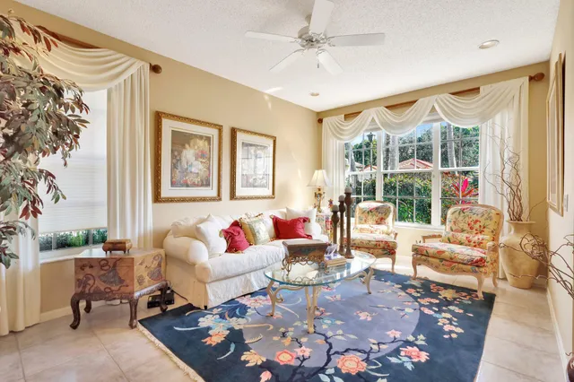 a living room with furniture large window and a table