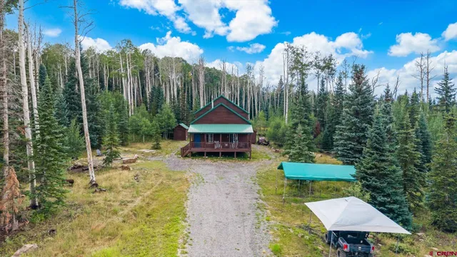 a view of a house with a yard fire pit and outdoor seating