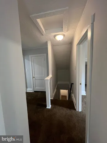 a view of hall way with mirror