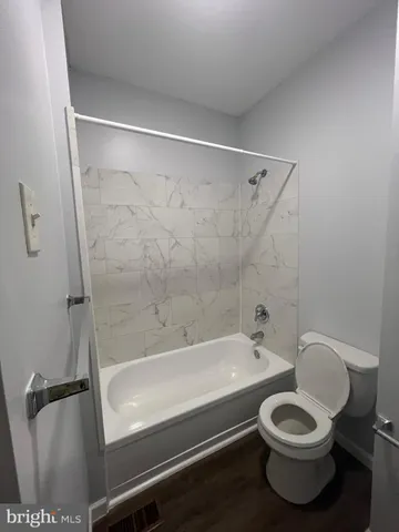 a bathroom with a toilet and a bathtub