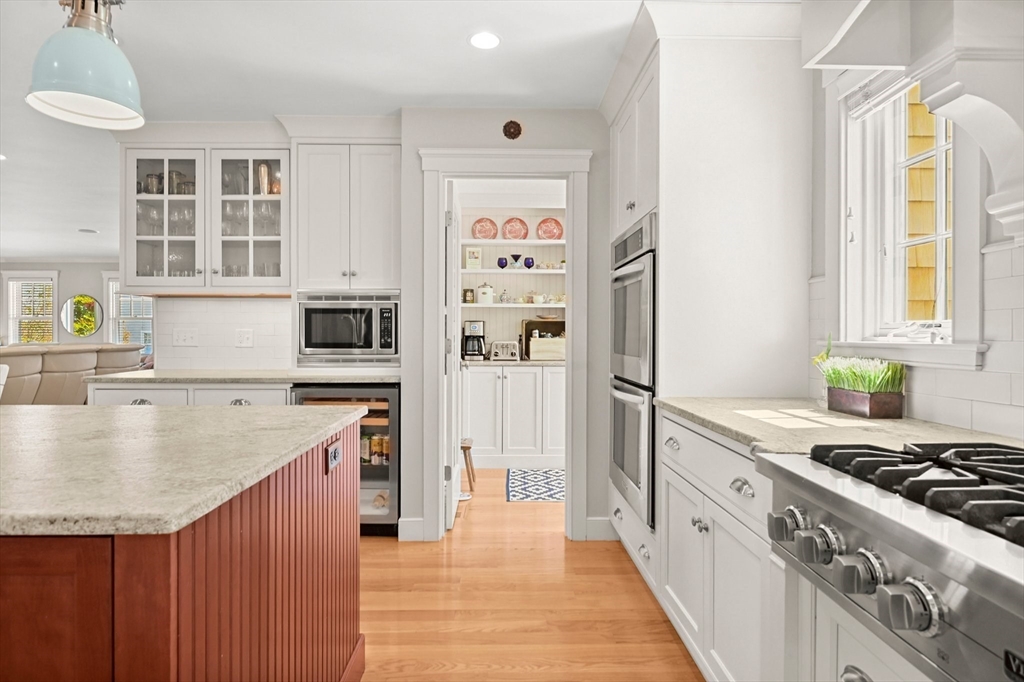 11 Whites Ferry Landing Marshfield, MA 02050 - Photo 17 of 42 a kitchen with stainless steel appliances granite countertop a refrigerator a stove and a sink with wooden floor