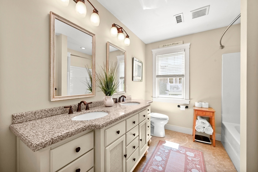 11 Whites Ferry Landing Marshfield, MA 02050 - Photo 21 of 42 a bathroom with a granite countertop sink a toilet and a mirror