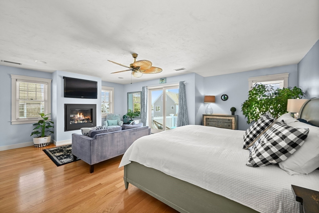 11 Whites Ferry Landing Marshfield, MA 02050 - Photo 26 of 42 a bedroom with a bed and a fireplace