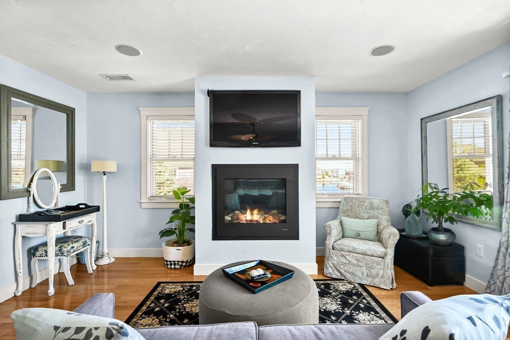 11 Whites Ferry Landing Marshfield, MA 02050 - Photo 27 of 42 a living room with furniture a flat screen tv and a fireplace