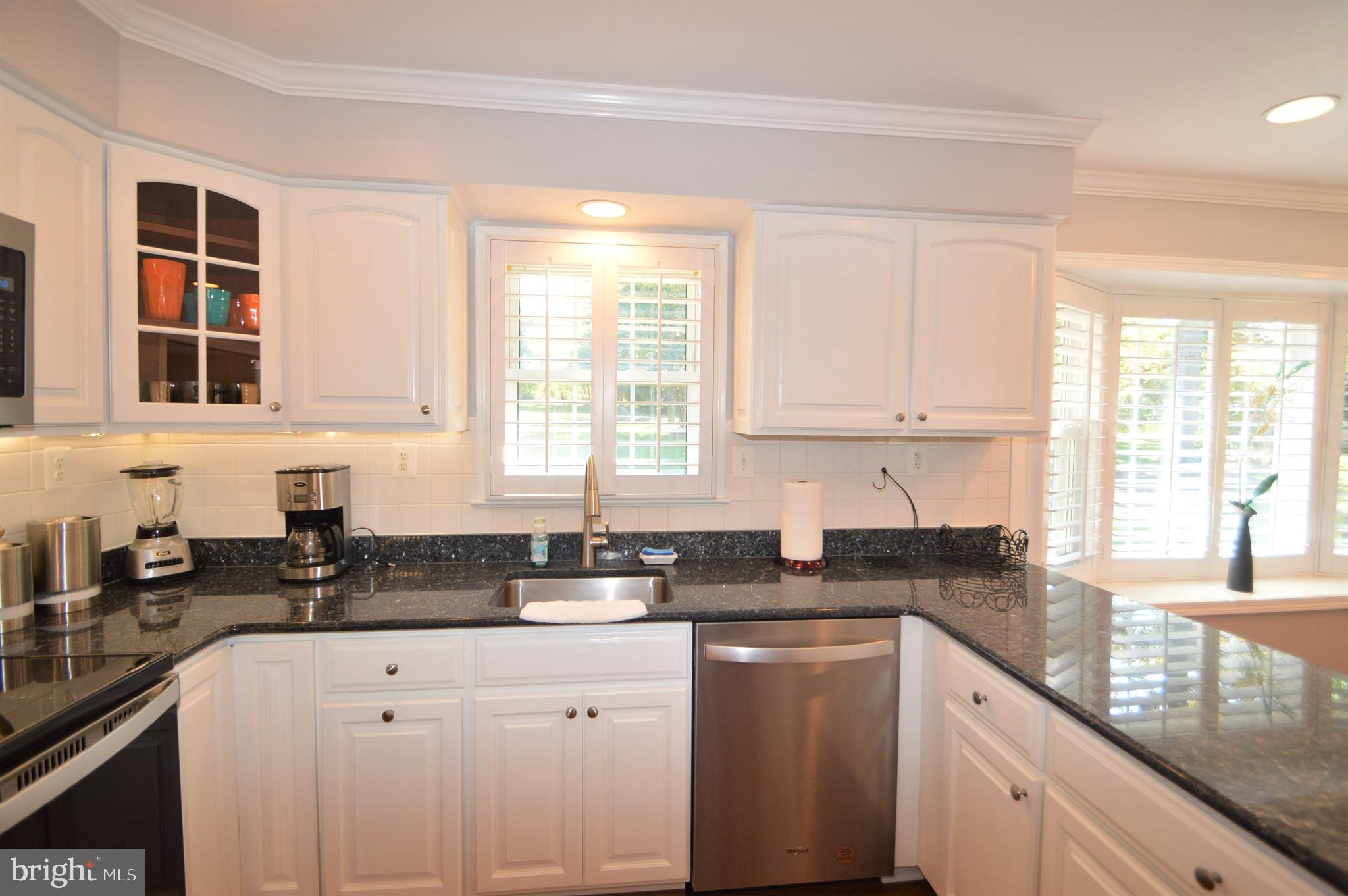 12614 Oxon Road Herndon, VA 20171 - Photo 31 of 71 a kitchen with granite countertop a sink a stove a counter space and cabinets