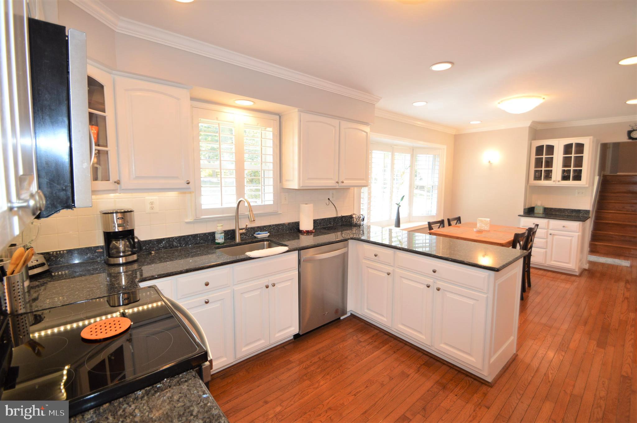 12614 Oxon Road Herndon, VA 20171 - Photo 32 of 71 a kitchen with granite countertop a sink and a stove top oven