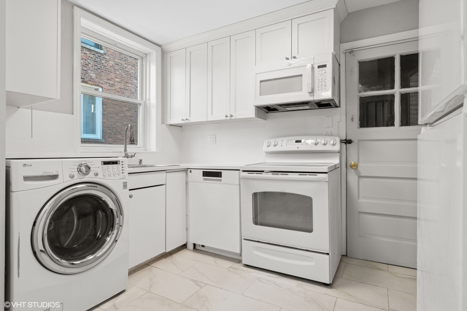 1143 East 50th Street, Unit 2 Chicago, IL 60615 - Photo 11 of 29 a kitchen with stainless steel appliances white cabinets and a sink