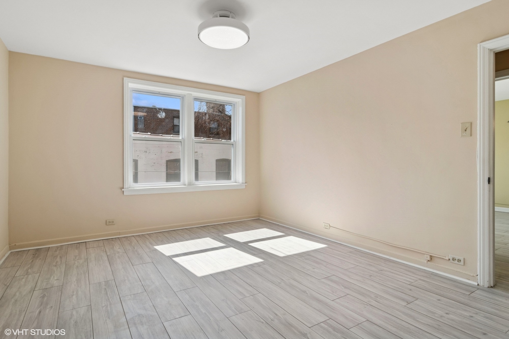 1143 East 50th Street, Unit 2 Chicago, IL 60615 - Photo 22 of 29 an empty room with wooden floor and windows