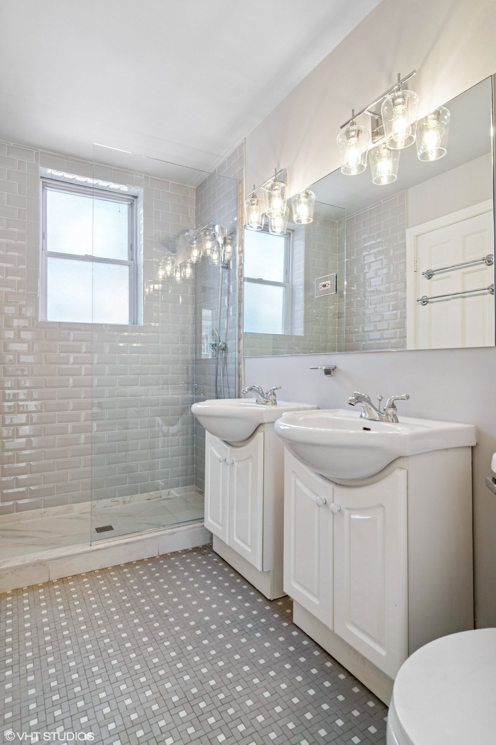 1143 East 50th Street, Unit 2 Chicago, IL 60615 - Photo 28 of 29 a bathroom with a sink a toilet and shower