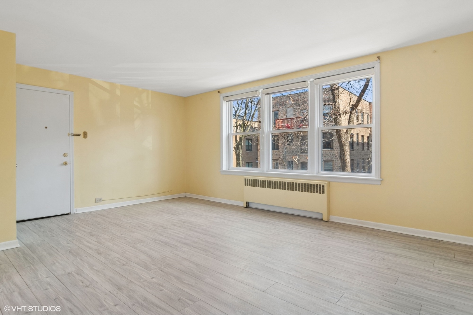 1143 East 50th Street, Unit 2 Chicago, IL 60615 - Photo 5 of 29 a view of an empty room with wooden floor and a window