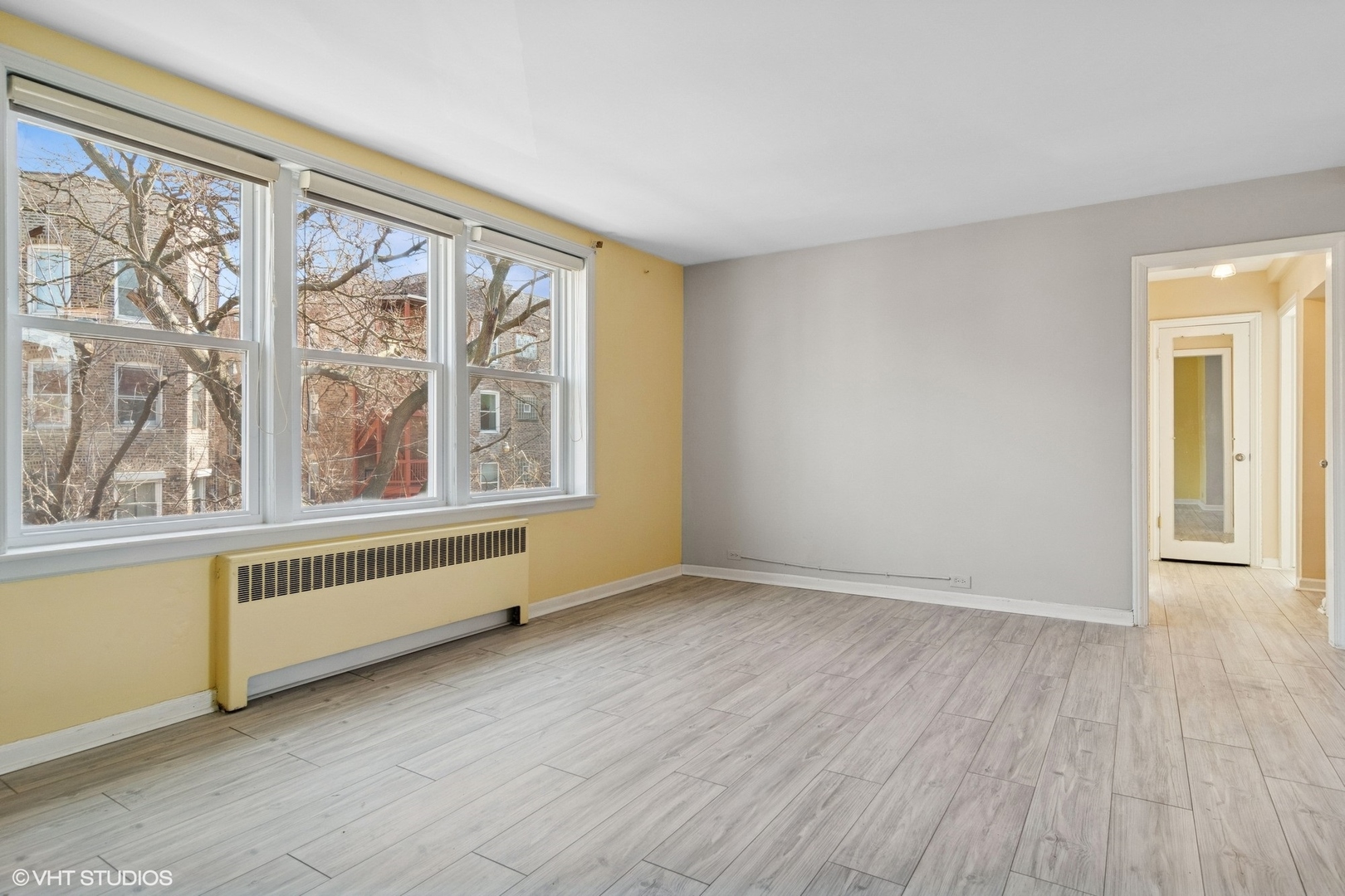 1143 East 50th Street, Unit 2 Chicago, IL 60615 - Photo 7 of 29 wooden floor in an empty room with a window